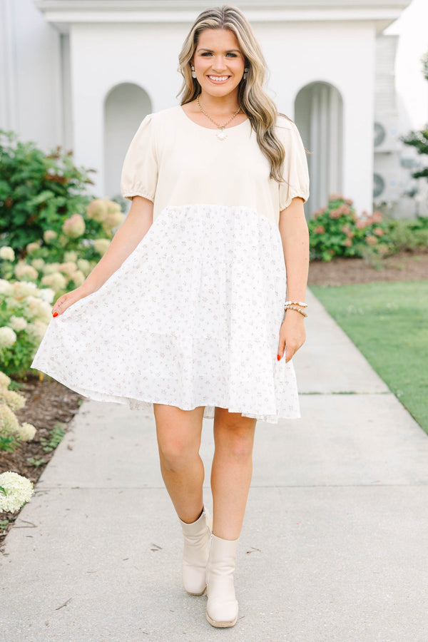 Plus size cream dress with bubble sleeves and a tiered floral skirt, featuring a flowy fit.