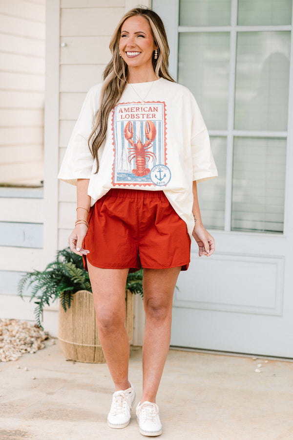 Plus Size copper windbreaker shorts with a smocked waistband and side slit hem.