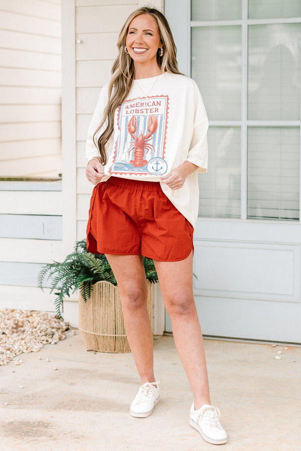 Plus Size copper windbreaker shorts with a smocked waistband and side slit hem.
