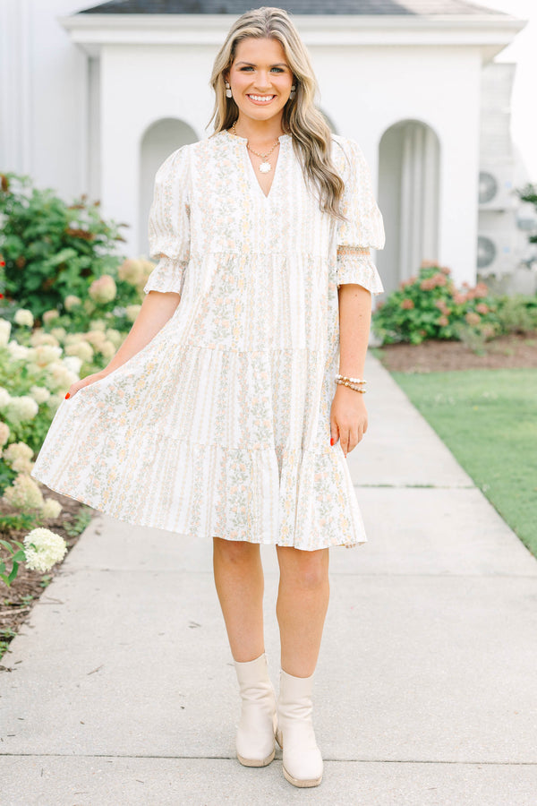 Plus Size cream tiered mini dress with a floral stripe pattern, V-neckline, and puff sleeves.