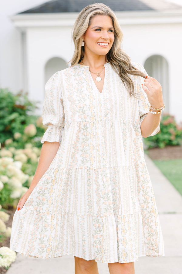 Plus Size cream tiered mini dress with a floral stripe pattern, V-neckline, and puff sleeves.
