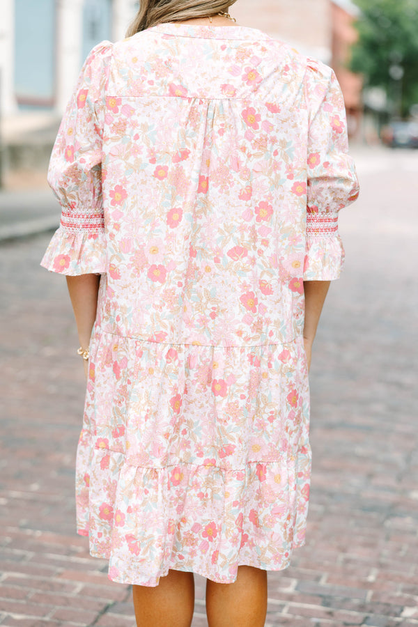 Plus Size pink floral mini dress with a split v-neck, tiered skirt, and smocked bell sleeves.