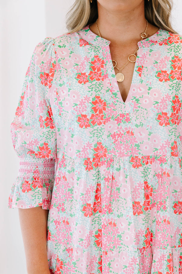 Plus size pink floral tiered dress with a flowy fit and ruffle smocked sleeves.