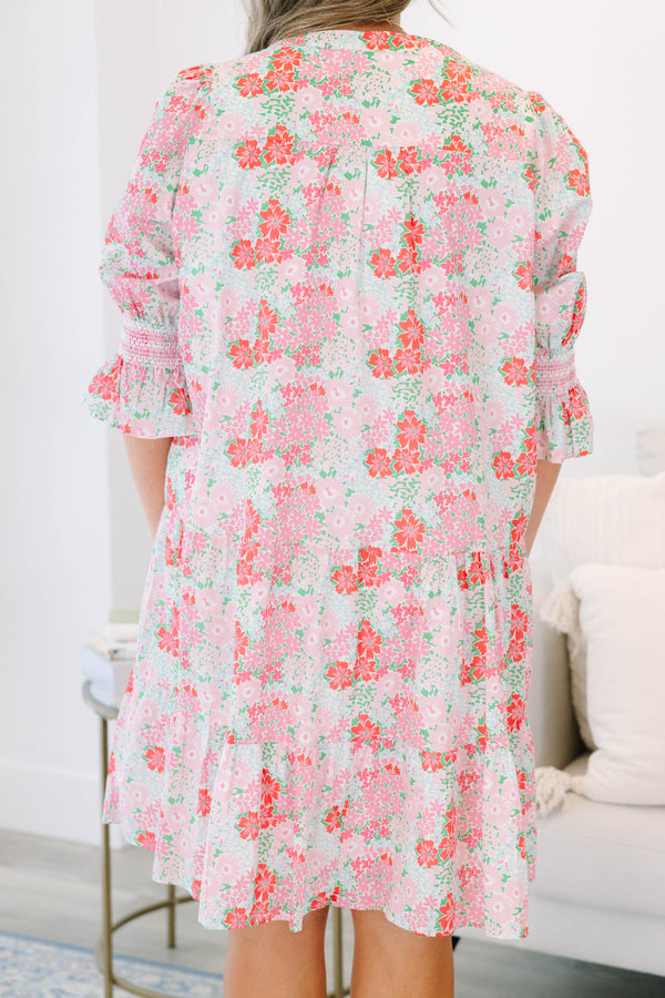 Plus size pink floral tiered dress with a flowy fit and ruffle smocked sleeves.
