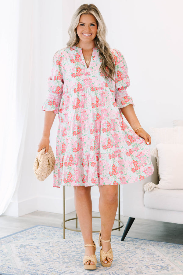 Plus size pink floral tiered dress with a flowy fit and ruffle smocked sleeves.