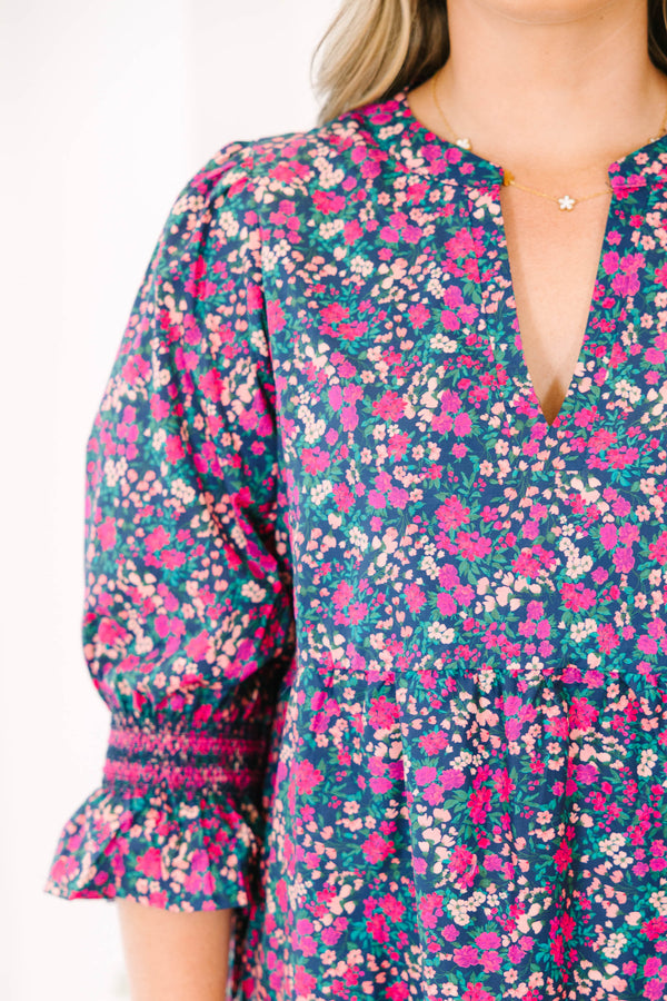 Plus Size tiered mini dress in a pink and navy floral print with a V-neckline and ruffled sleeves.