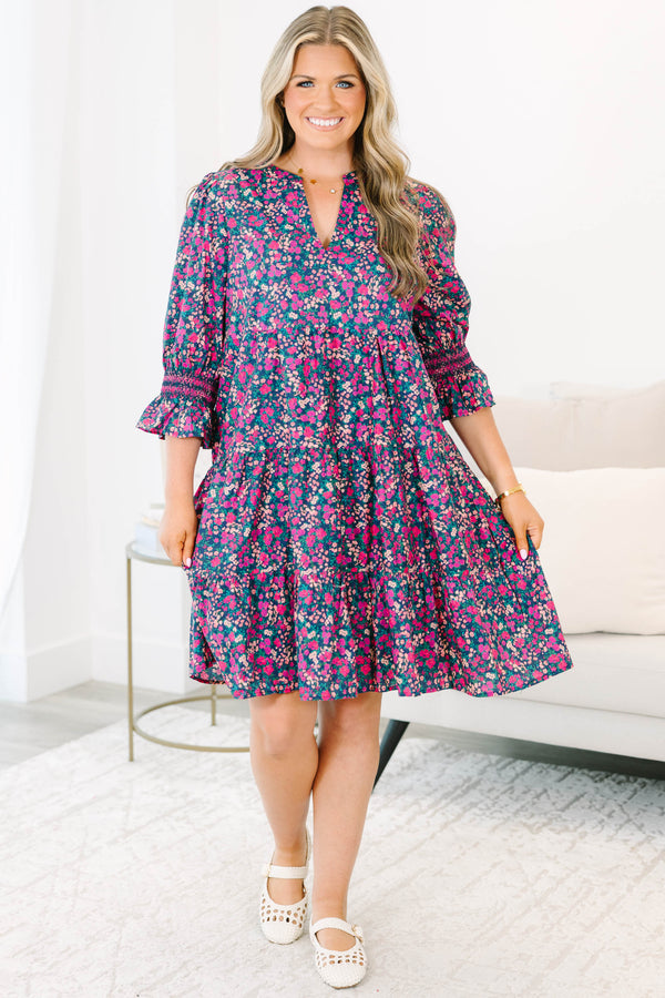 Plus Size tiered mini dress in a pink and navy floral print with a V-neckline and ruffled sleeves.