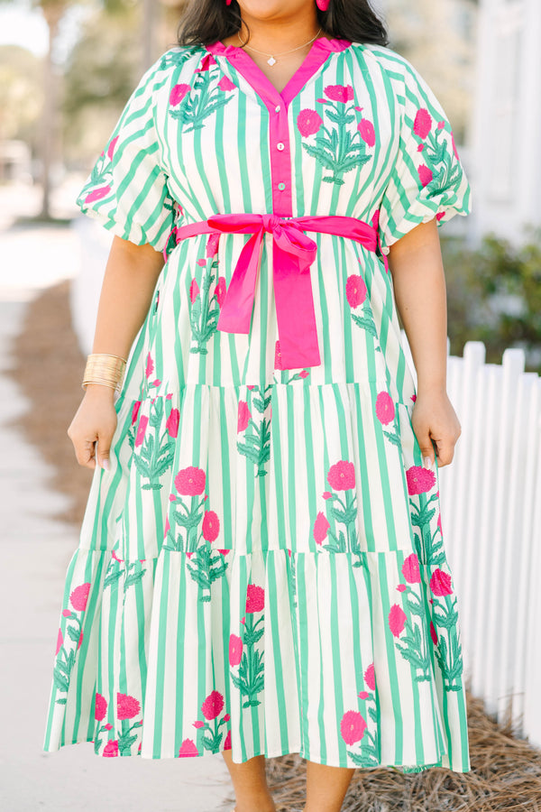 Chic Soul plus size clothing, green striped tiered maxi dress with a pink strip outlining the v-neckline and going down to the bottom of the buttons on the chest as well as a pink belt that ties around the waist and floral block pattern throughout