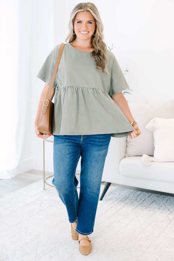 Plus Size olive green short sleeve babydoll top with a round neckline and ruffled waist seam.