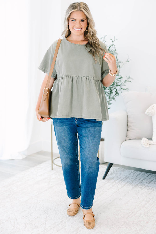 Plus Size olive green short sleeve babydoll top with a round neckline and ruffled waist seam.
