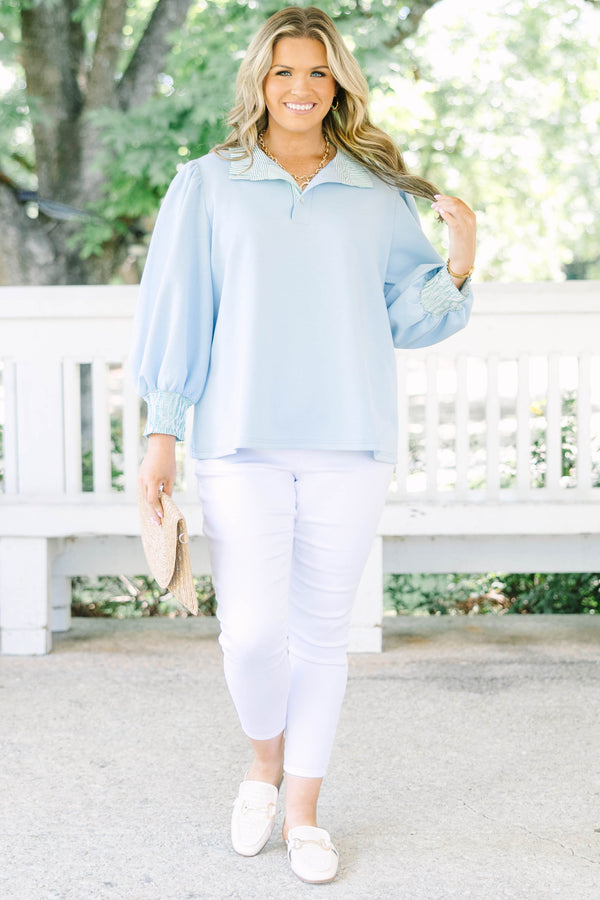 Plus size top in light blue with striped ruffle collar and smocked cuffs.
