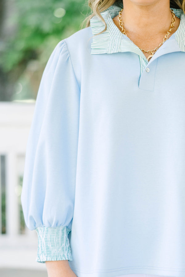 Plus size top in light blue with striped ruffle collar and smocked cuffs.
