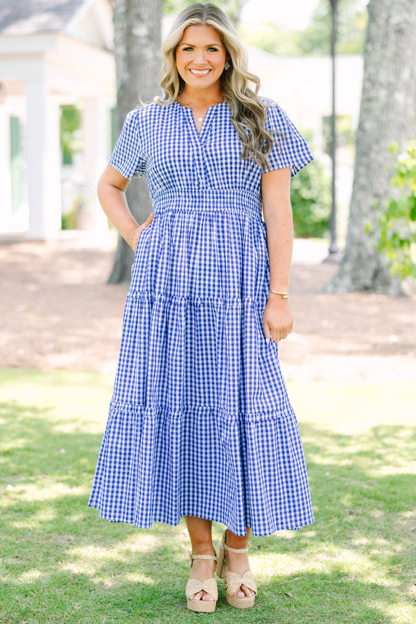 Plus size navy blue gingham midi dress with a smocked waist, V-neckline, and tiered flowy skirt.
