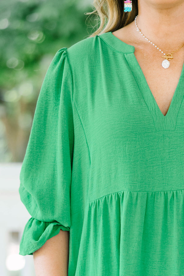 Plus Size green tiered midi dress with a V-neckline and three-quarter length sleeves.