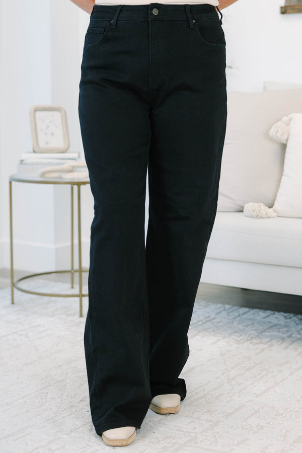 Plus size black wide leg jeans in a stretchy, high-waisted fit for a confident, feminine look.