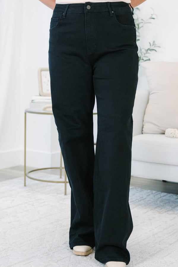 Plus size black wide leg jeans in a stretchy, high-waisted fit for a confident, feminine look.