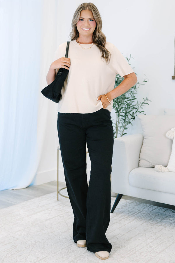 Plus size black wide leg jeans in a stretchy, high-waisted fit for a confident, feminine look.