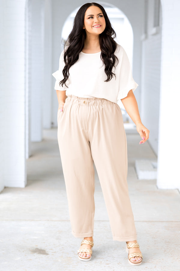 Plus Size taupe pants with an elastic paperbag waist, button detail, and cuffed ankles.