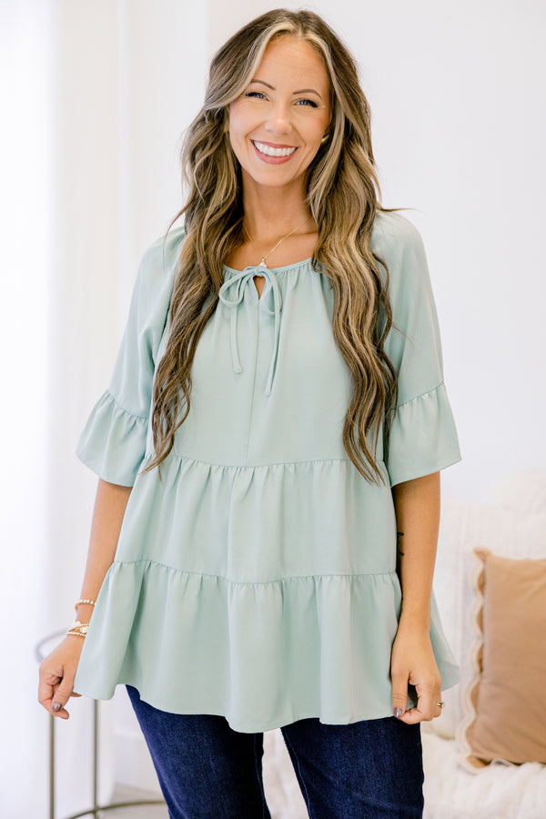 Chic Soul plus size clothing, short-sleeve ruffled dusty sage green baby doll top with a subtle v-neckline and tie on the neckline