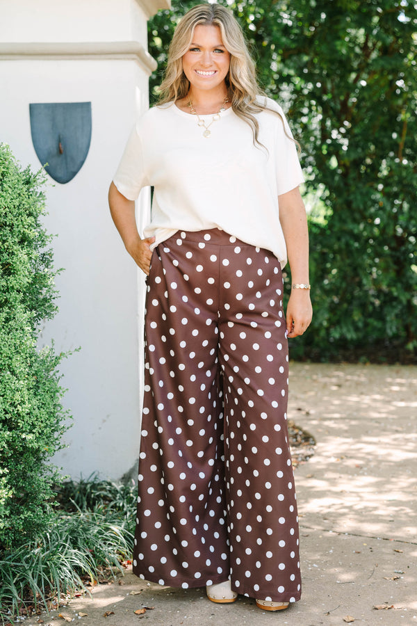High-rise chocolate brown palazzo pants with white polka dots and a flowy wide-leg silhouette.