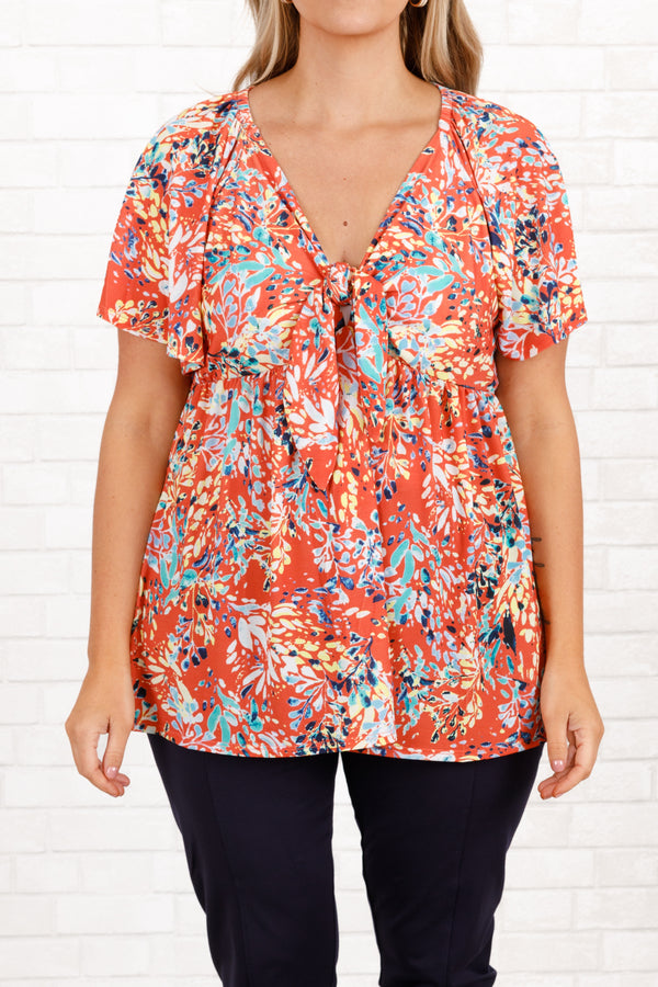 Chic Soul plus size clothing, coral floral pattern babydoll top with a knotted neckline and flowy sleeves