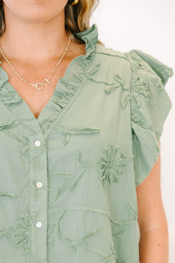 Plus Size olive green textured floral top with ruffle cap sleeves and a button-down front.