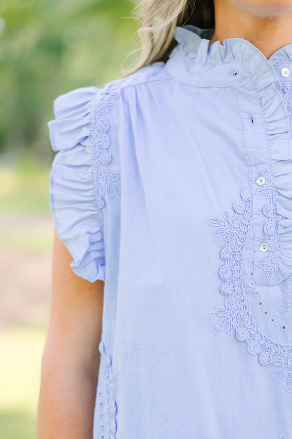 Plus Size light blue sleeveless top with ruffle trim, high neck, and intricate floral embroidery.
