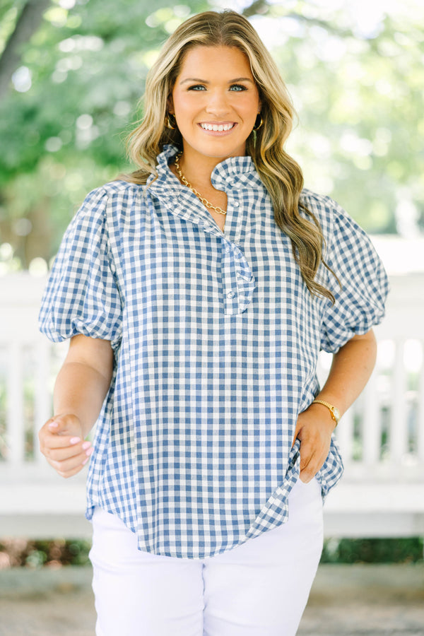 Plus size navy gingham top with puff sleeves and a ruffled collar.