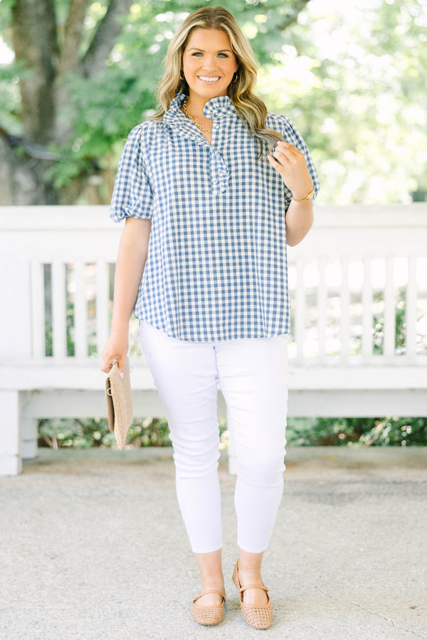 Plus size navy gingham top with puff sleeves and a ruffled collar.