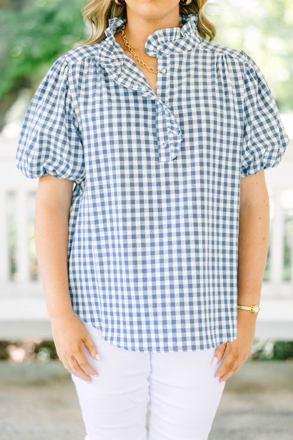 Plus size navy gingham top with puff sleeves and a ruffled collar.