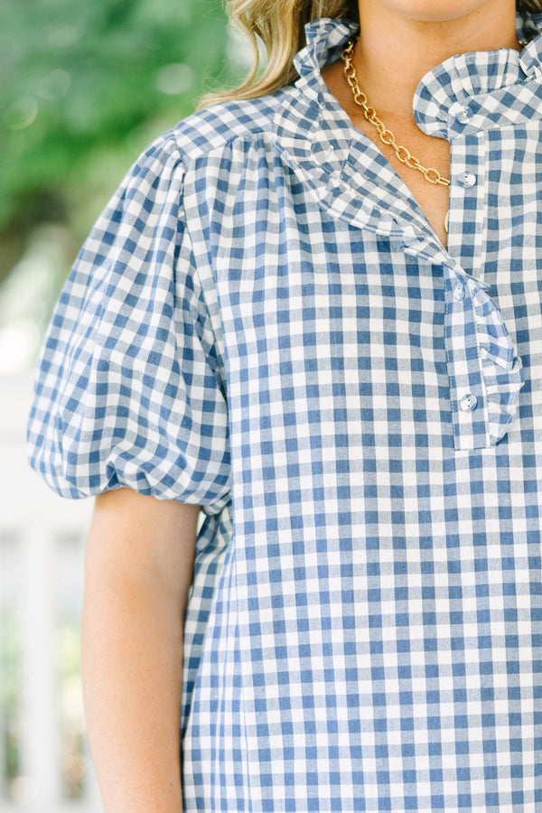 Plus size navy gingham top with puff sleeves and a ruffled collar.