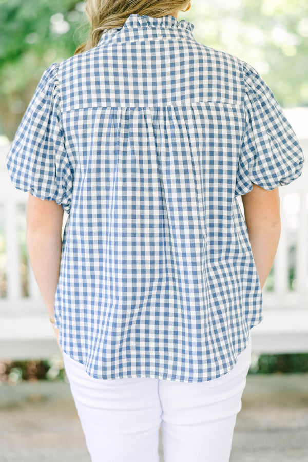 Plus size navy gingham top with puff sleeves and a ruffled collar.