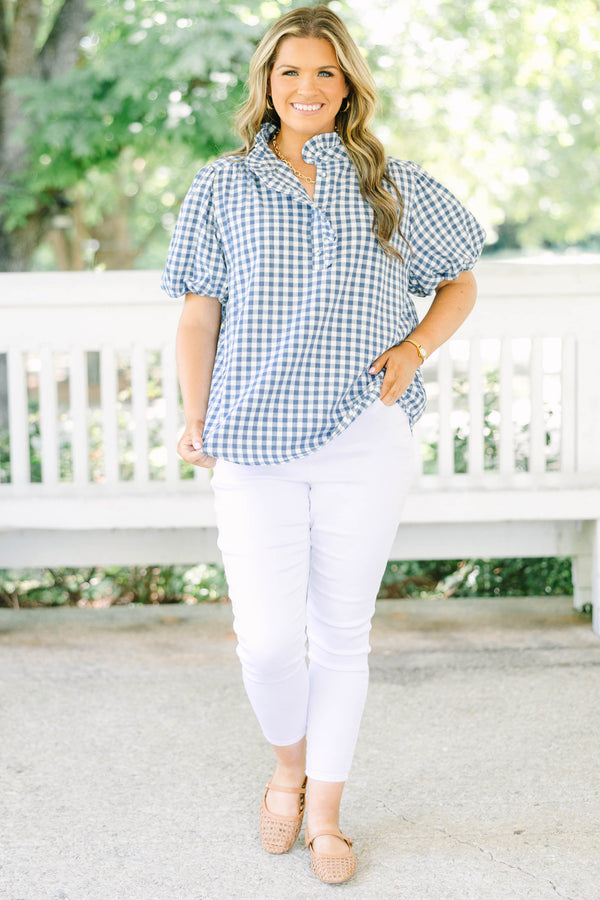 Plus size navy gingham top with puff sleeves and a ruffled collar.