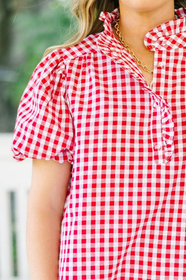 Plus size red and white gingham top with ruffle collar and short puff sleeves.