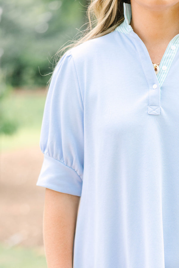Plus Size light blue cotton dress with short puff sleeves, a collared neckline, and a ruffled hem.