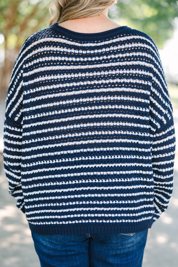 Plus Size navy and white striped knit sweater with a crew neckline and long sleeves.