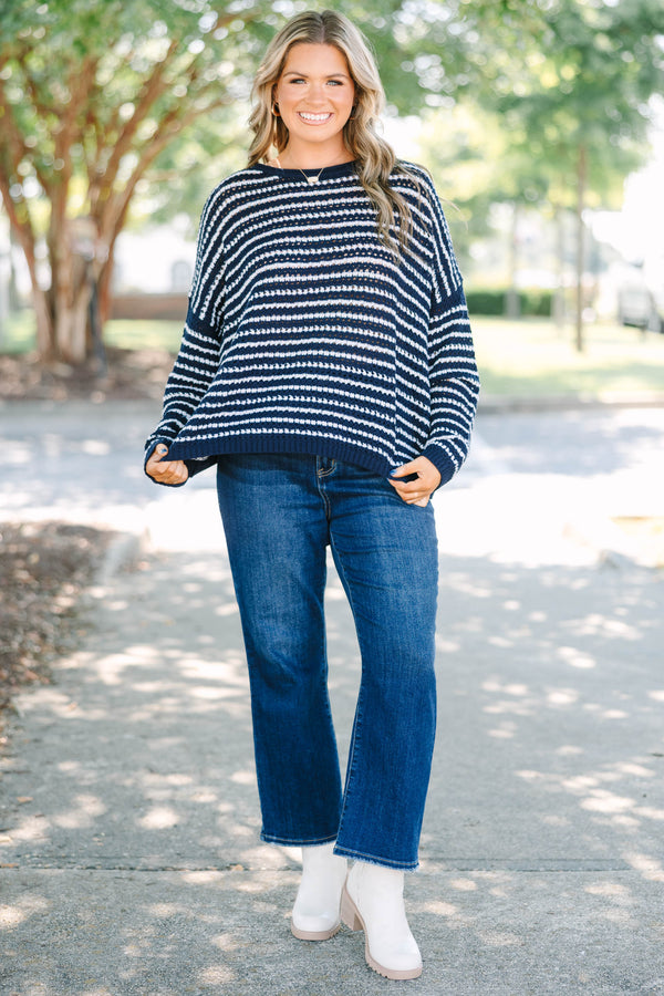 Plus Size navy and white striped knit sweater with a crew neckline and long sleeves.