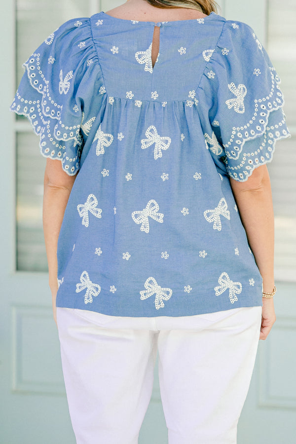 Chic Soul plus size clothing, denim top with flutter sleeves and white embroidered bows and flowers details throughout the top  
