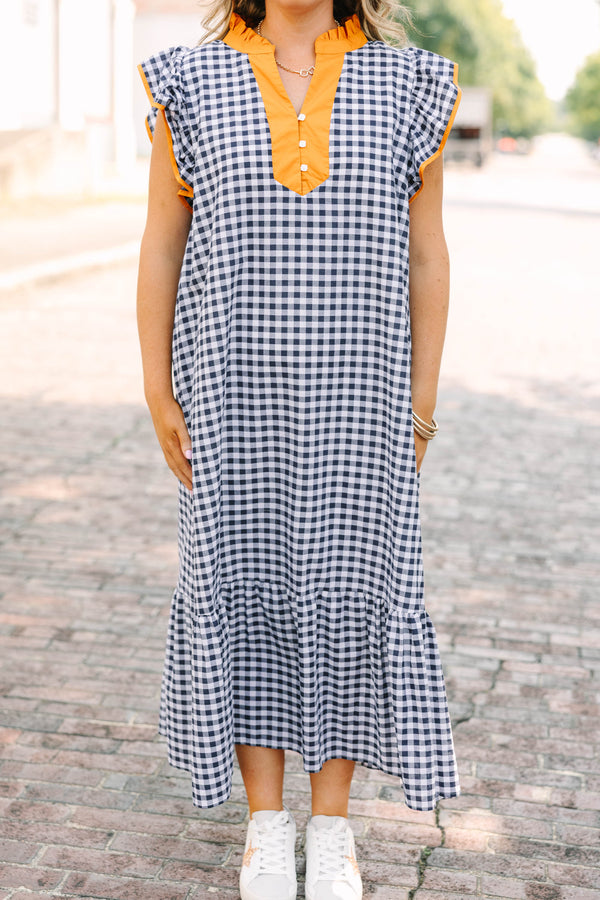 Plus Size navy and white gingham maxi dress with orange ruffle sleeves and a buttoned orange collar.