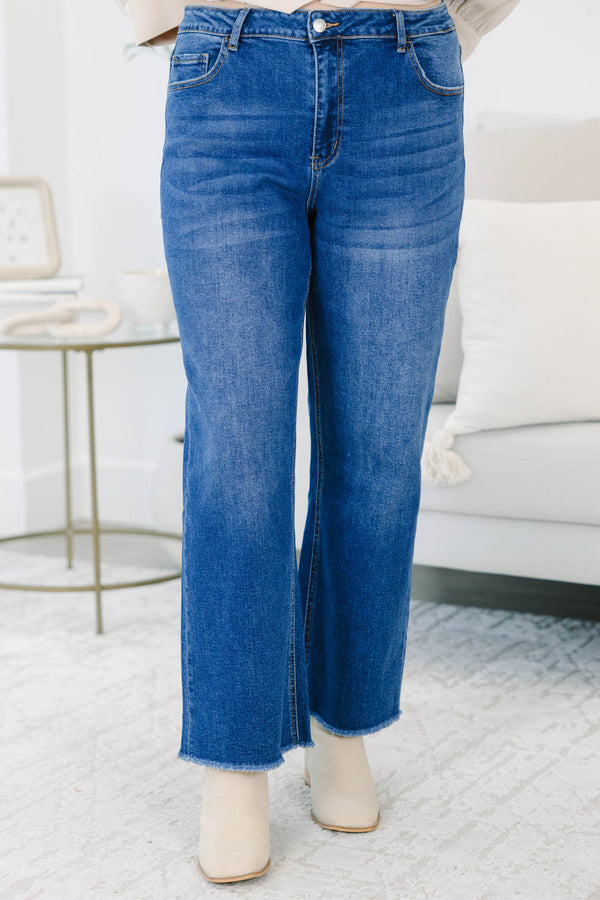 Plus Size dark wash straight leg jeans with a high waist and raw fringe hems.