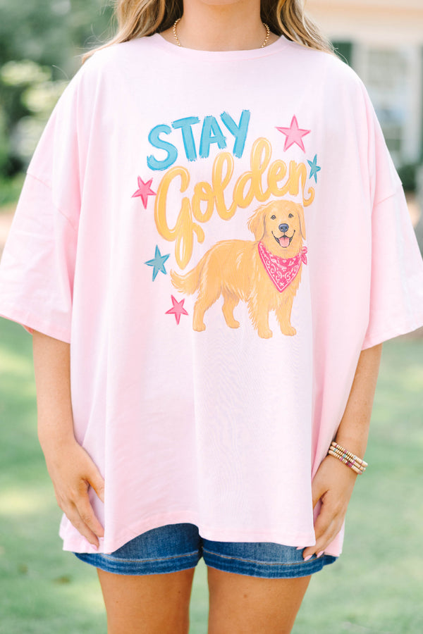 Plus size woman in a dusty pink  boyfriend tee with a golden retriever graphic.