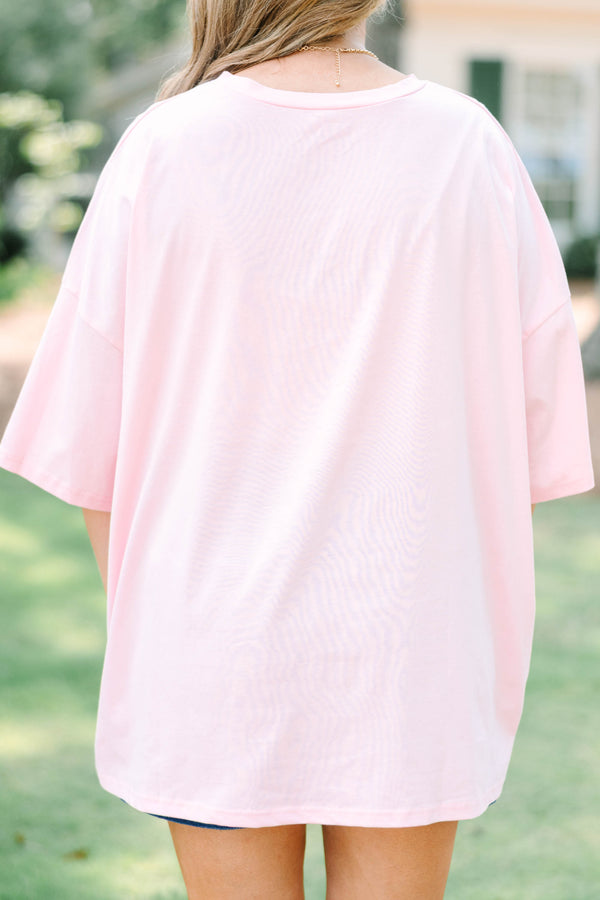 Plus size woman in a dusty pink  boyfriend tee with a golden retriever graphic.