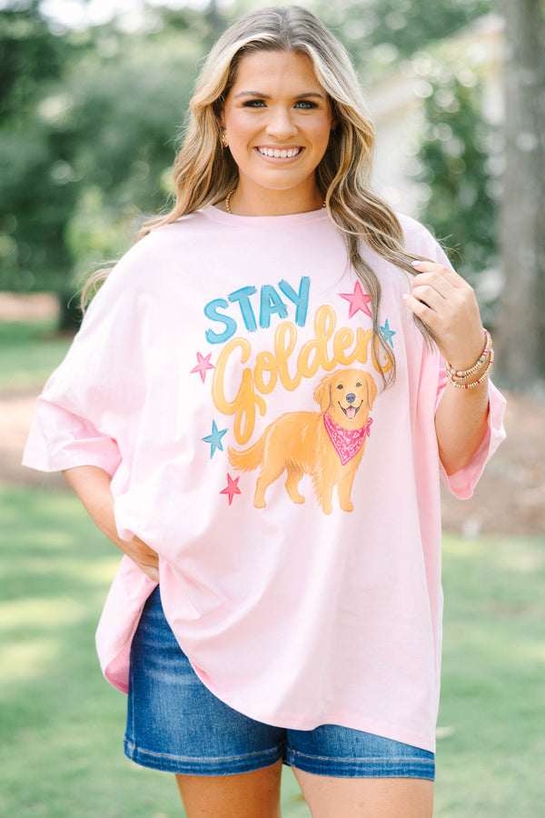 Plus size woman in a dusty pink  boyfriend tee with a golden retriever graphic.