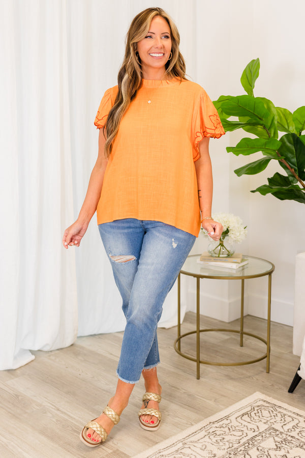 Chic Soul plus size clothing, short sleeve apricot orange top with smocked high neckline and darker orange embroidery on sleeves 