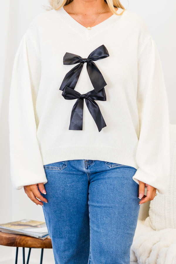 Chic Soul plus size clothing, white long sleeve knit sweater with v neckline with two black satin bows on the front with bubble sleeves