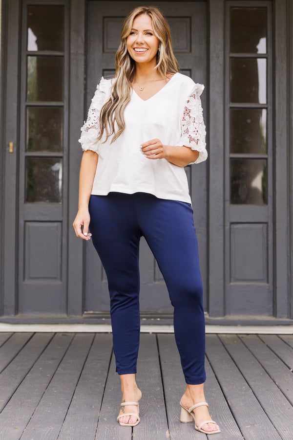 Plus Size navy cropped pants with a wide waistband and slim, stretchy fit.