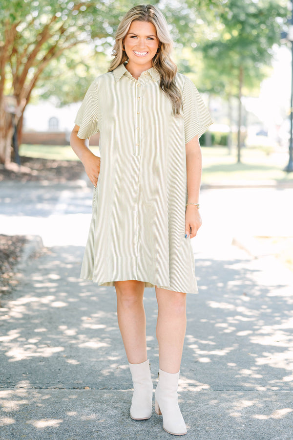 Plus size woman in a green stripe Sweet Breeze shirt dress with a flowy fit and button-down front.