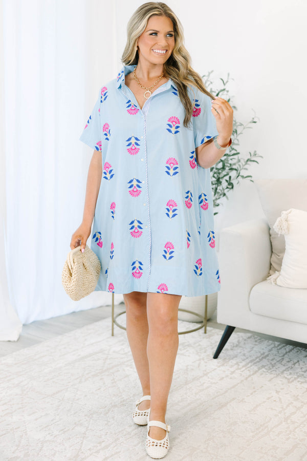 Plus size baby blue shirt dress with magenta floral embroidery, short sleeves, and a flowy fit.