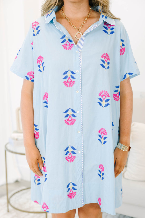 Plus size baby blue shirt dress with magenta floral embroidery, short sleeves, and a flowy fit.