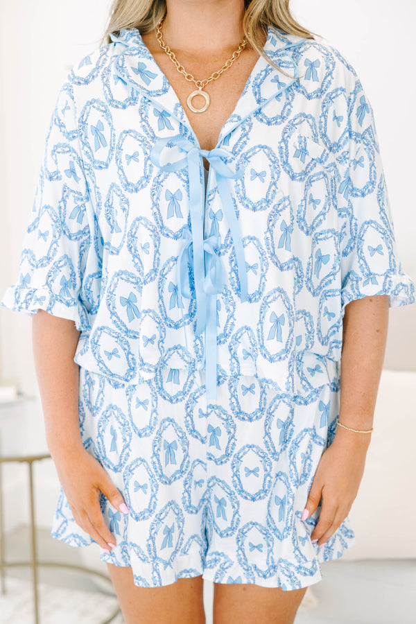 Plus Size blue and white bow print pajama set with a tie-front top and matching ruffled shorts.